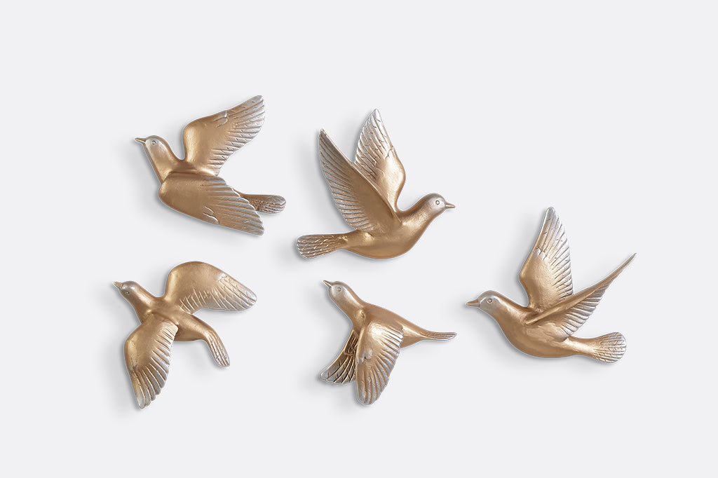A set of 5 gold birds posed in flight.