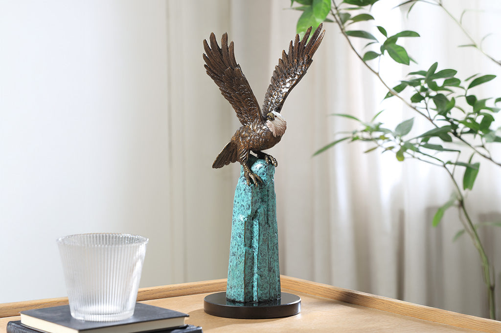 An eagle perched upon a stone.