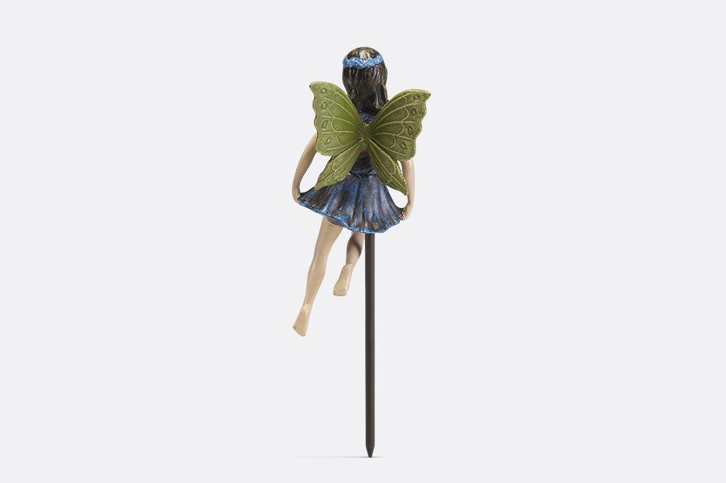 A plant pot stake sculpture of a fairy wearing blue.