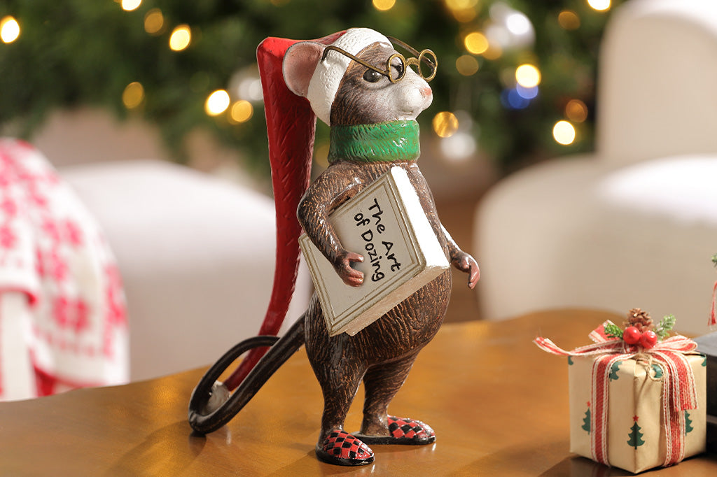 A mouse with glasses, a long night cap, slippers, a green scarf, and a book called "The Art of Dozing."
