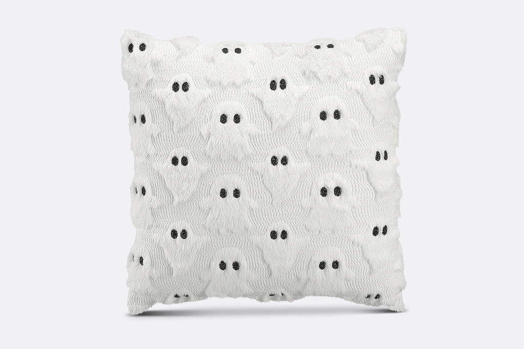 White textured pillow with black dots on a white background