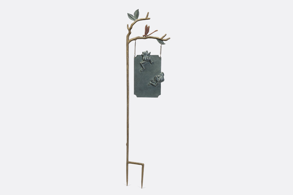 A staked sign with frogs, dragonflies, and branches, with a sign that reads "Frog Parking Only. All others will be toad."