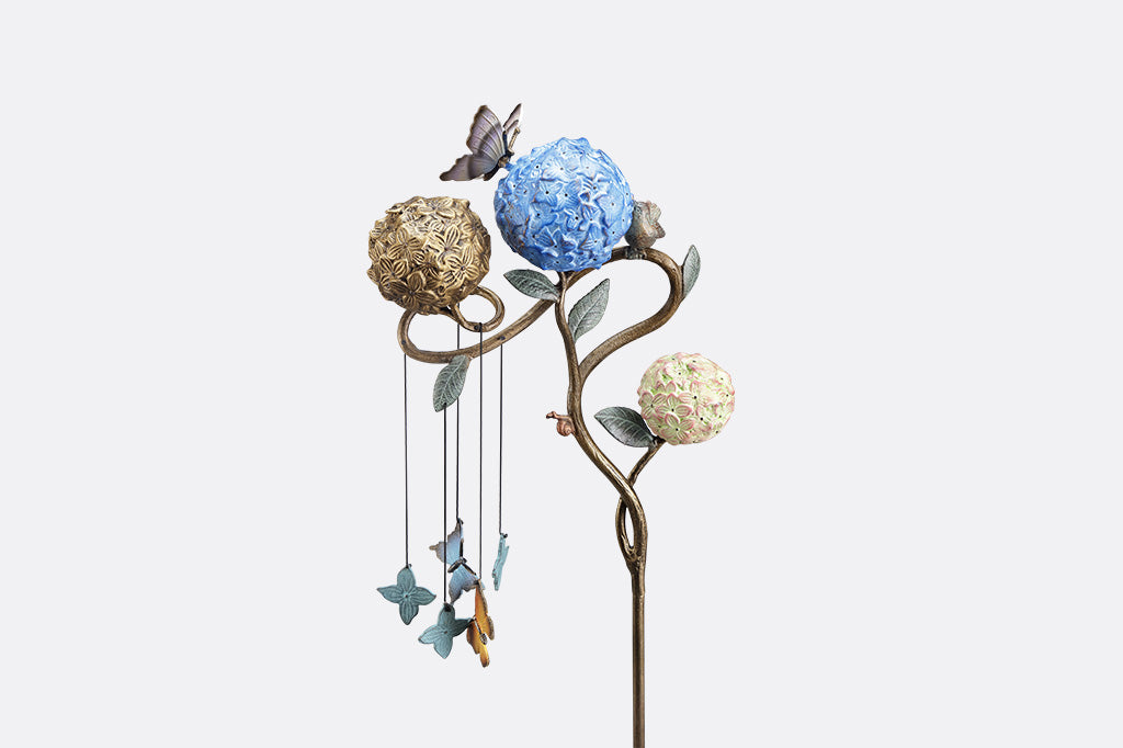Decorative garden stake with butterflies shot on white background, close up