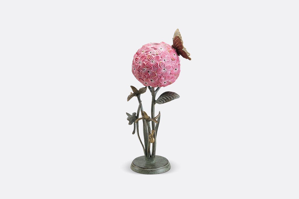 A single taper candleholder of a hydrangea blossom surrounded by a butterfly, dragonfly, and a snail.