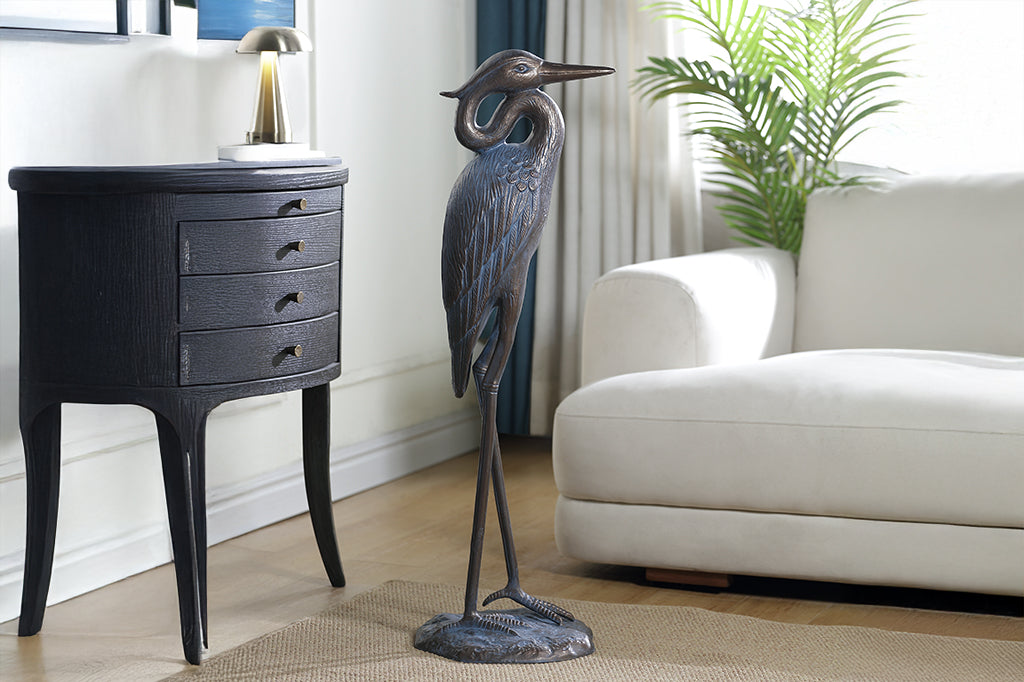 A sculpture of a heron with an arched neck.