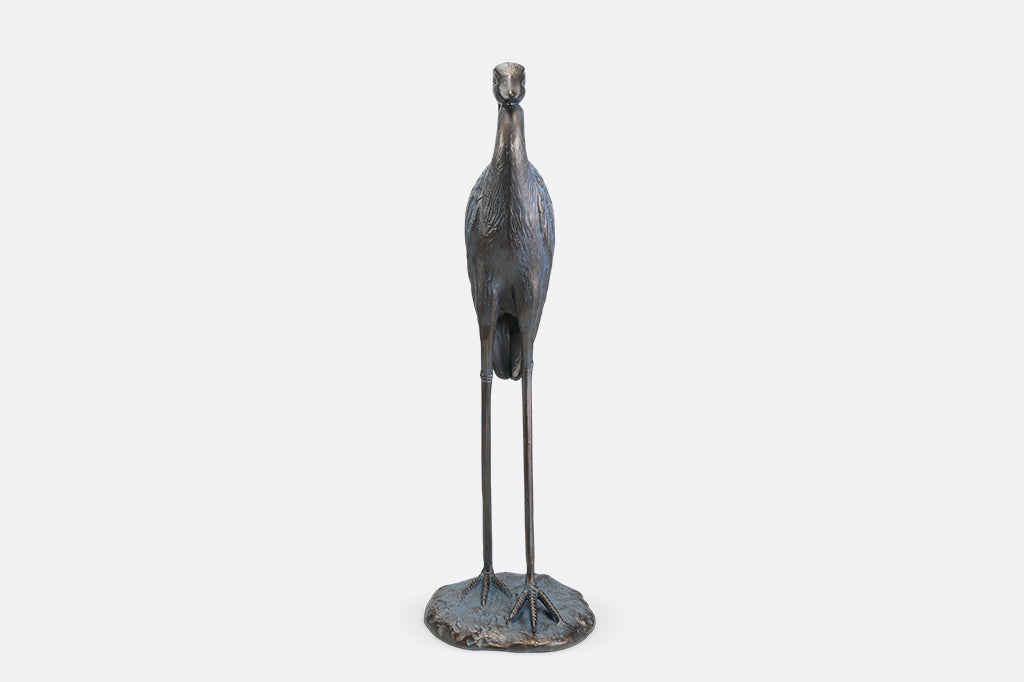 A sculpture of a heron with an arched neck.
