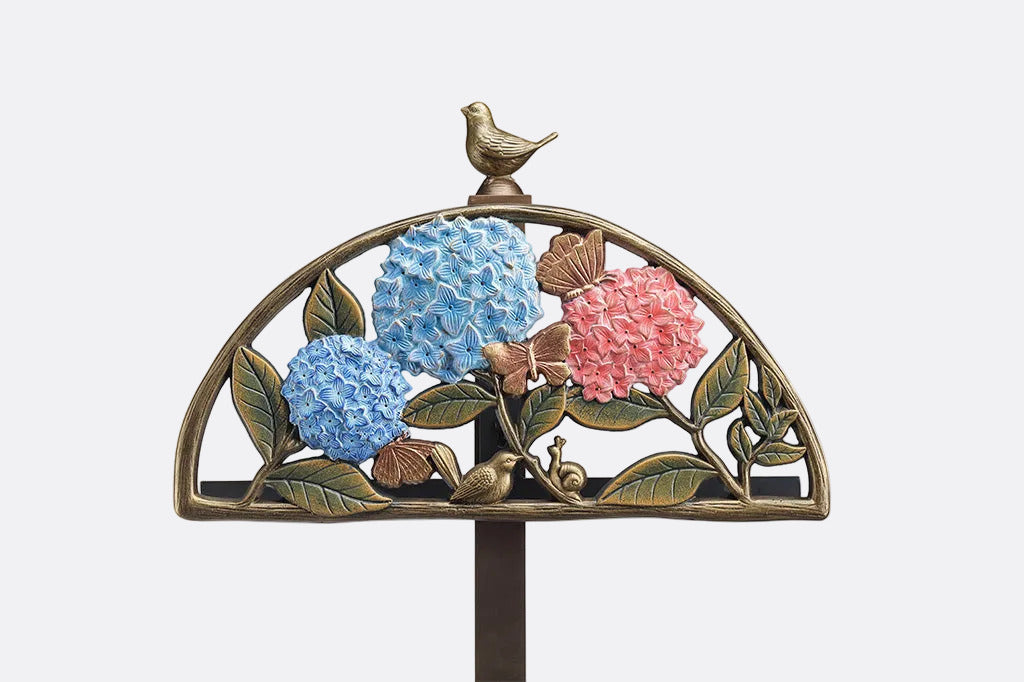 Closeup shot of Decorative garden stake with flowers and birds on a white background