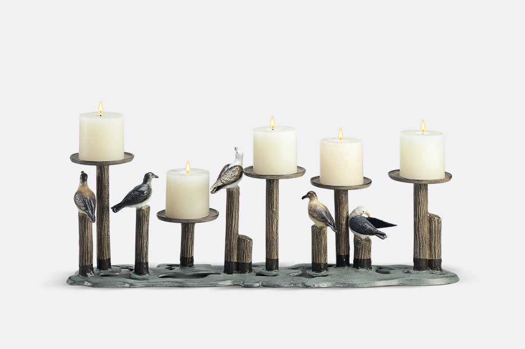 Decorative candle holder with birds on a white background