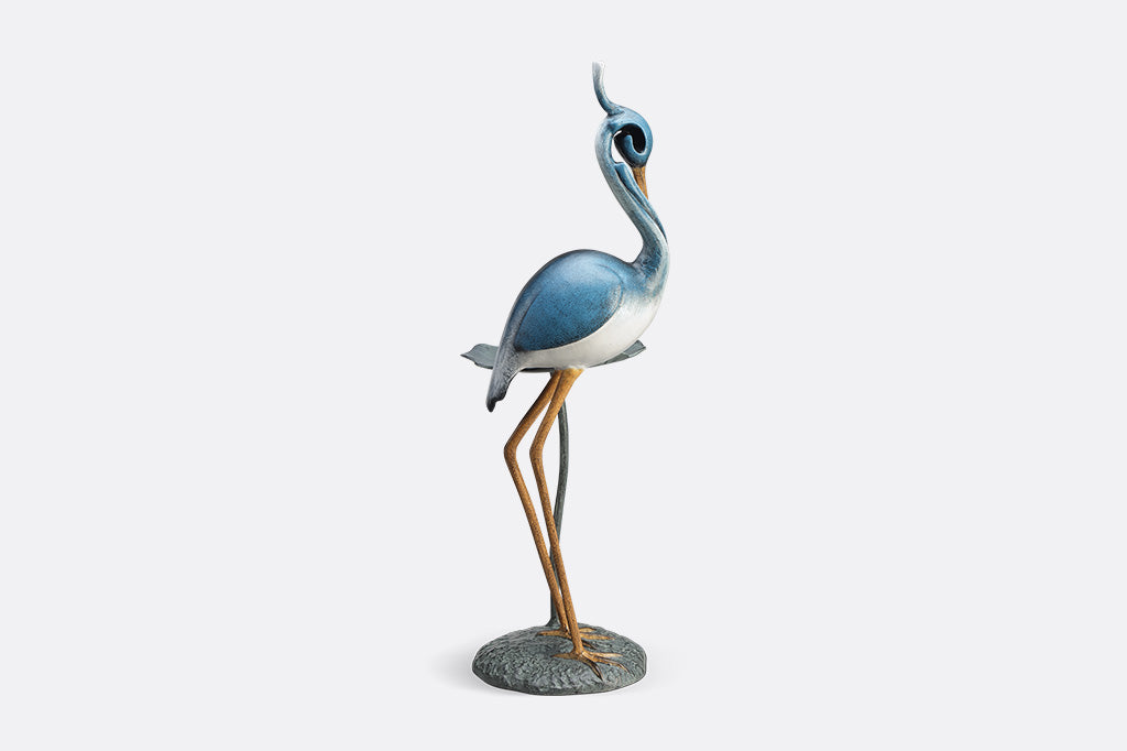 Blue heron figurine on a white background