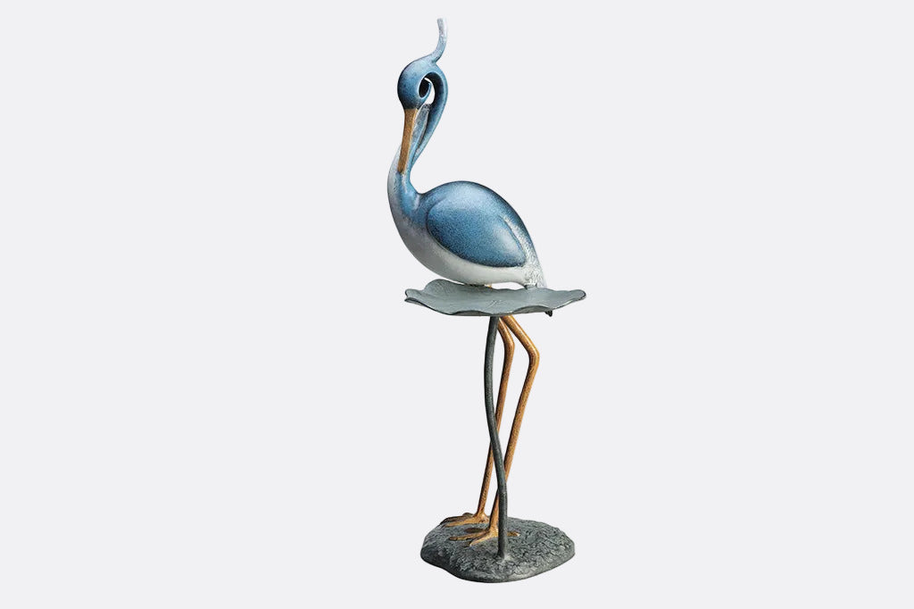 Blue heron figurine on a white background