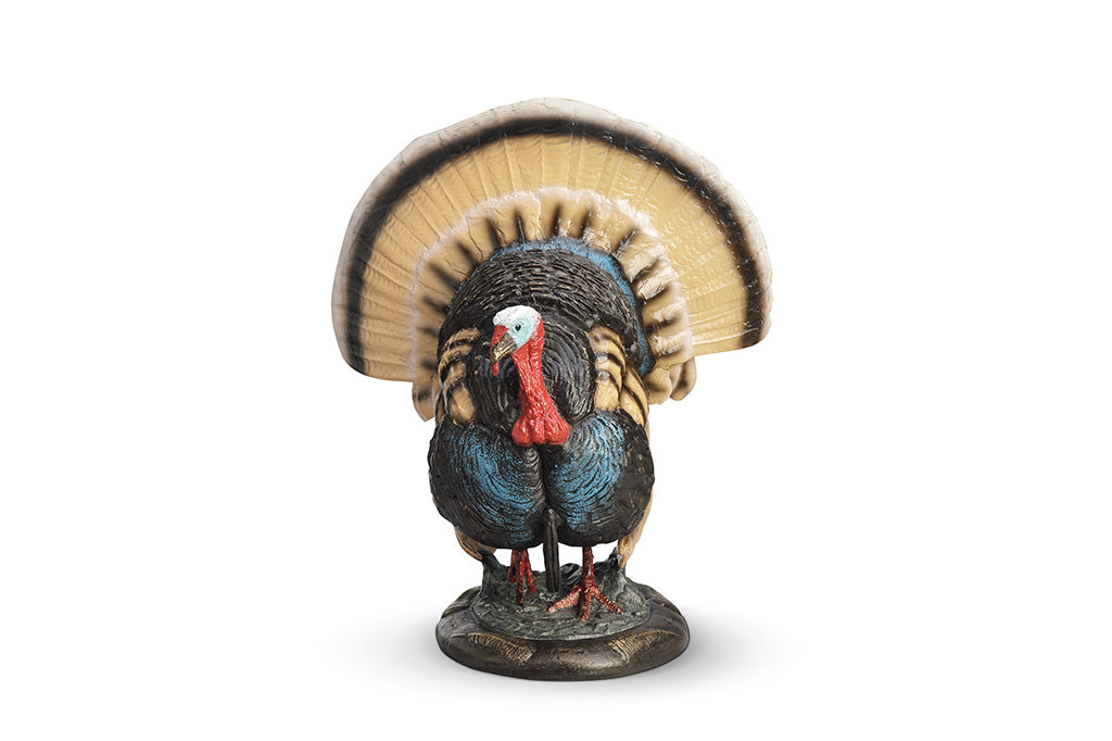 A colorful turkey sculpture with its feathers spread out.