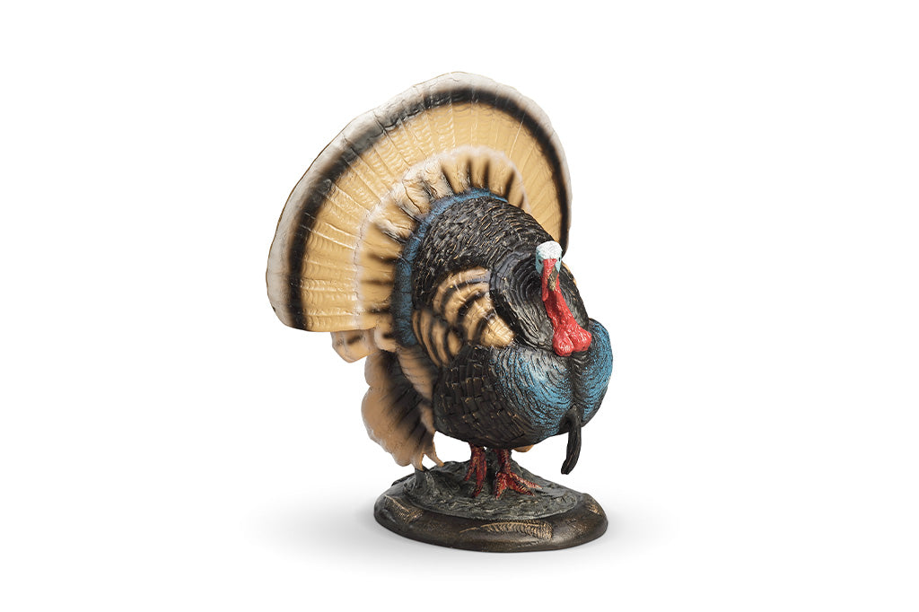 A colorful turkey sculpture with its feathers spread out.