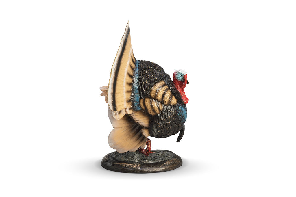 A colorful turkey sculpture with its feathers spread out.