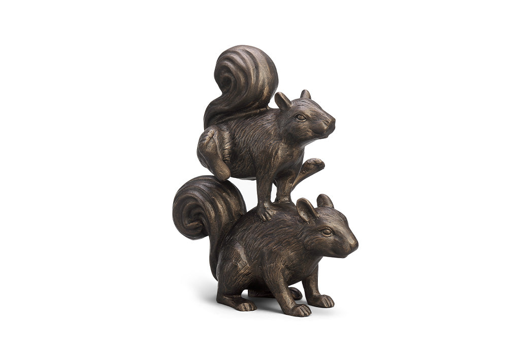A sculpture of two squirrels playing leapfrog and hopping over each other.