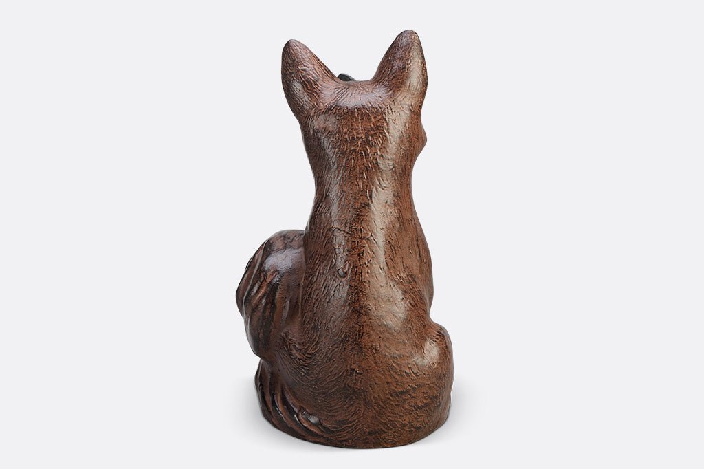 A sculpture of a blue butterfly landing on the nose of a fox.