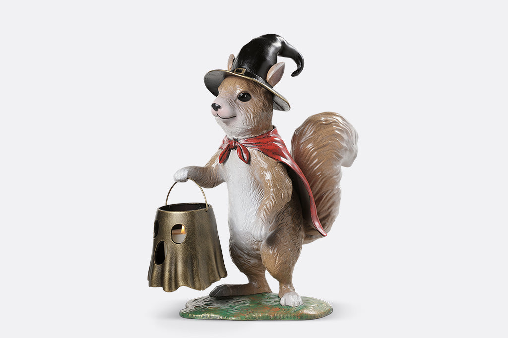 Squirrel figurine wearing a top hat and holding a bucket on a white background