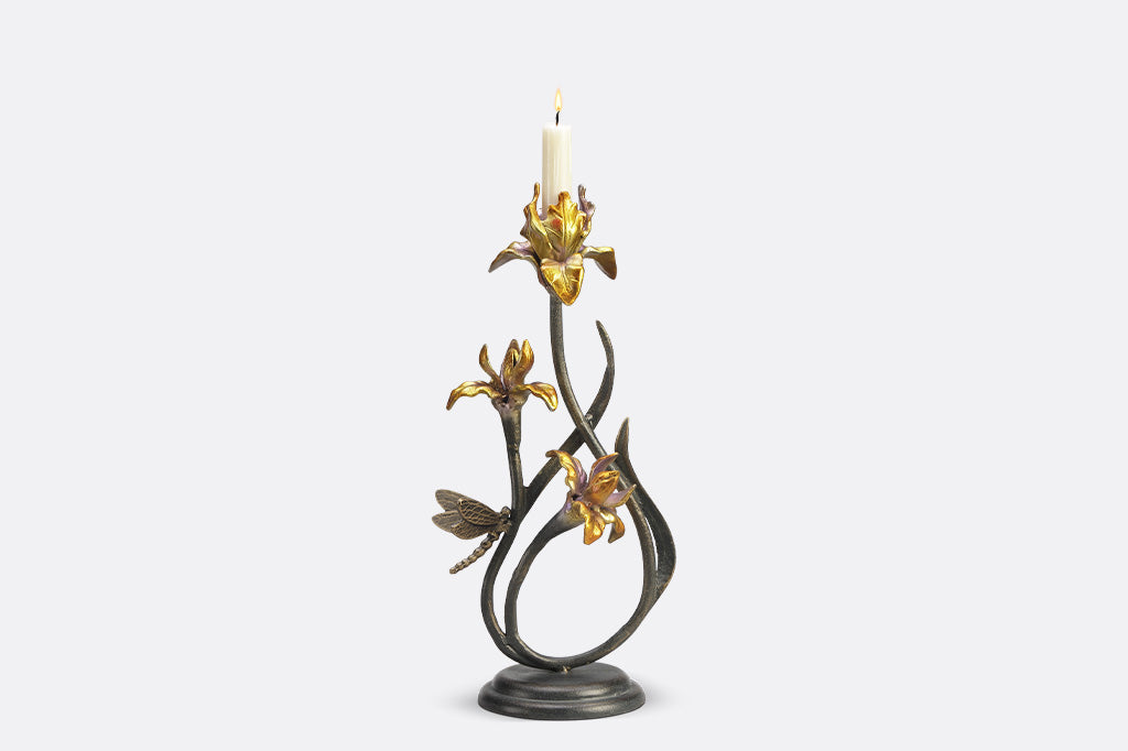 A pair of taper candleholders shaped like iris flowers with a dragonfly.