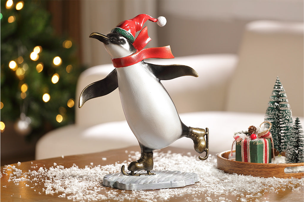 A sculpture of a penguin wearing a scarf and Santa hat ice skating.