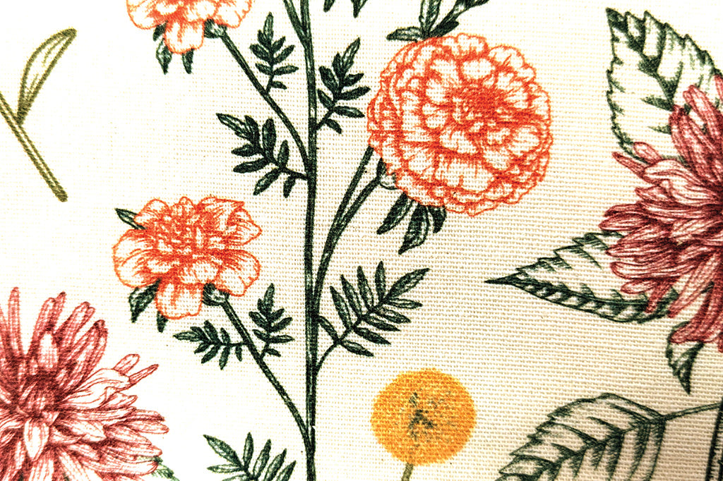 A close up of a towel with printed details of vibrant flowers.