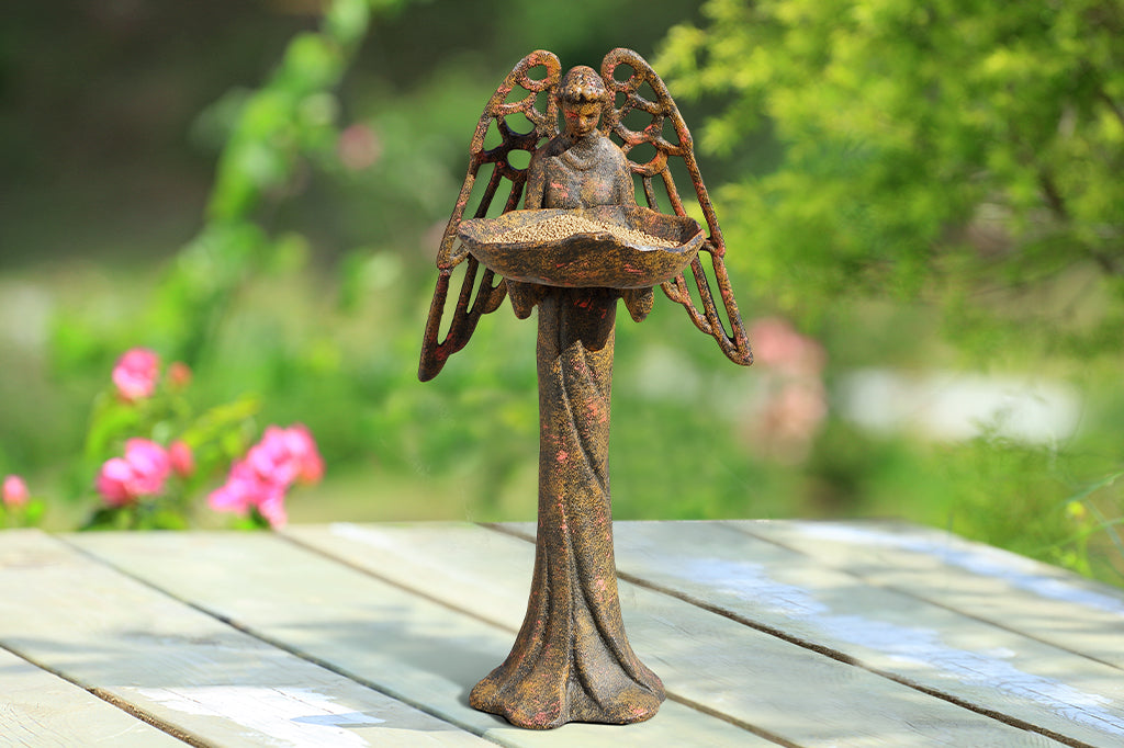 cast metal angel bird feeder with red and orange highlights 