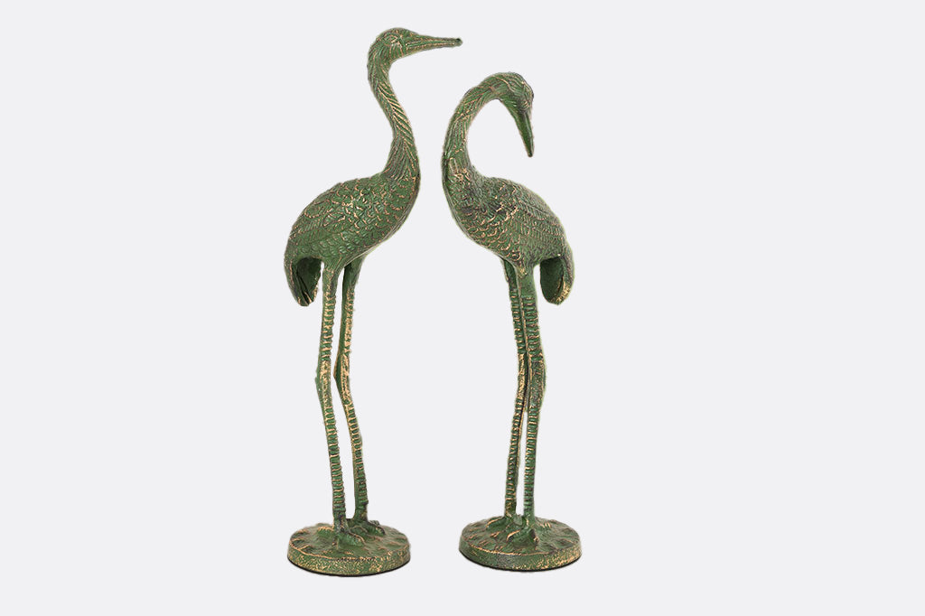 metal cranes with mossy green patina