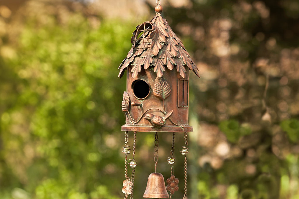 metal decorative windchime shaped like a birdhouse cottage