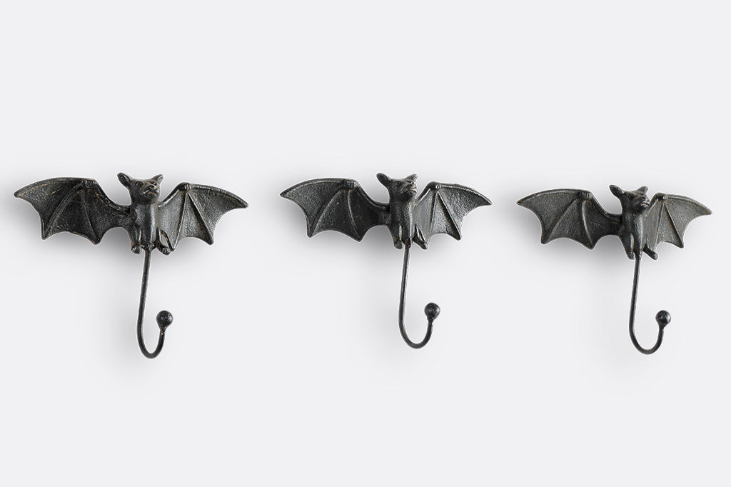 3 bat shaped wall hooks of cast iron shown on wall