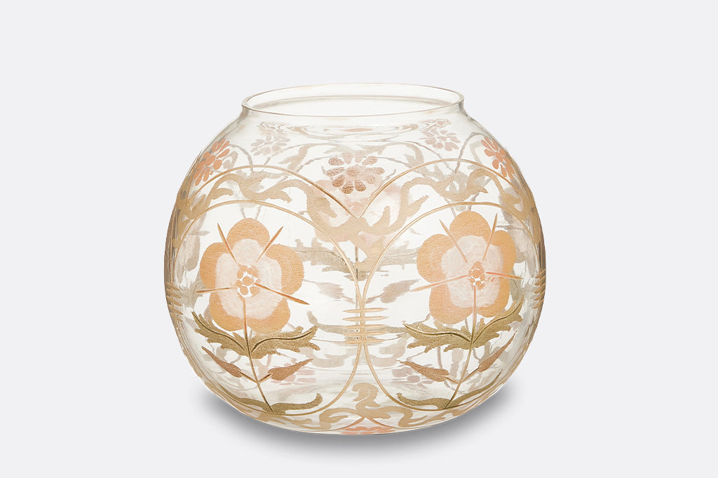 A clear, glass vase bowl featuring floral patterns with warm tones of yellow, orange, and green.