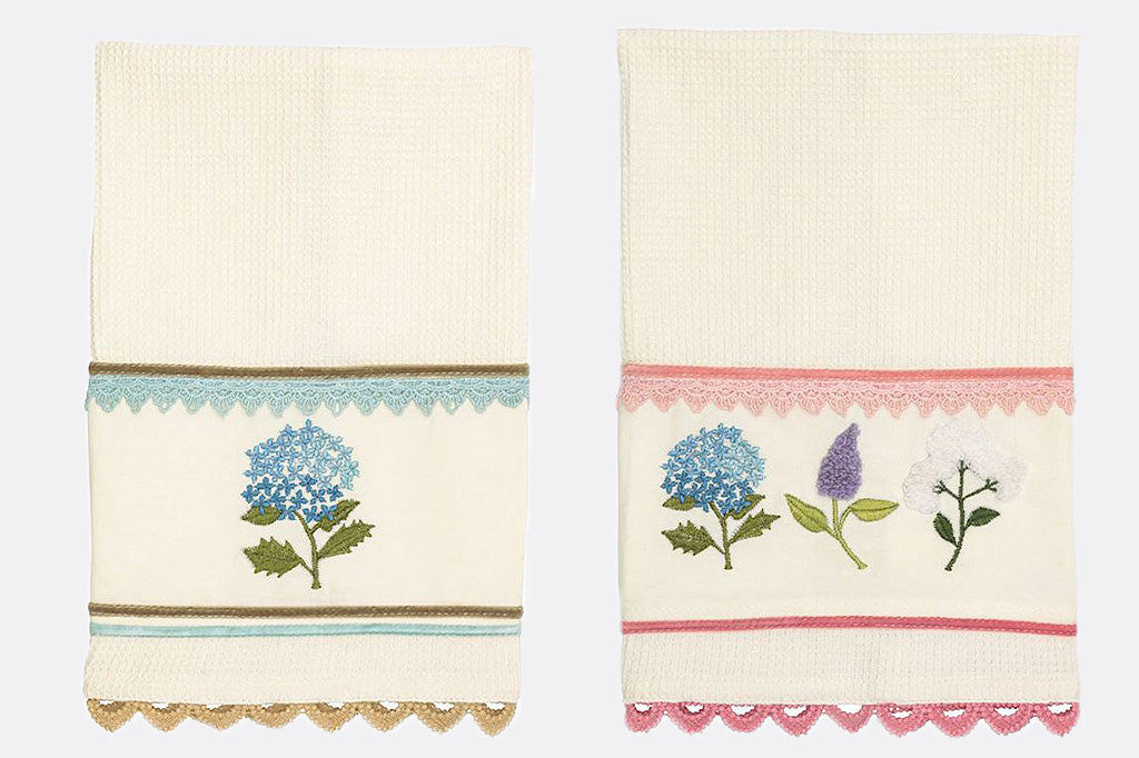 A set of four cotton dishtowels featuring spring flowers in vibrant pastel colors.