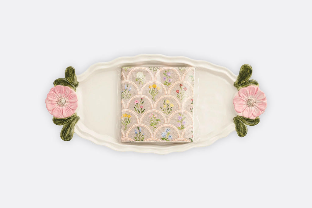 A tray with pink flowers and a set of matching napkins.