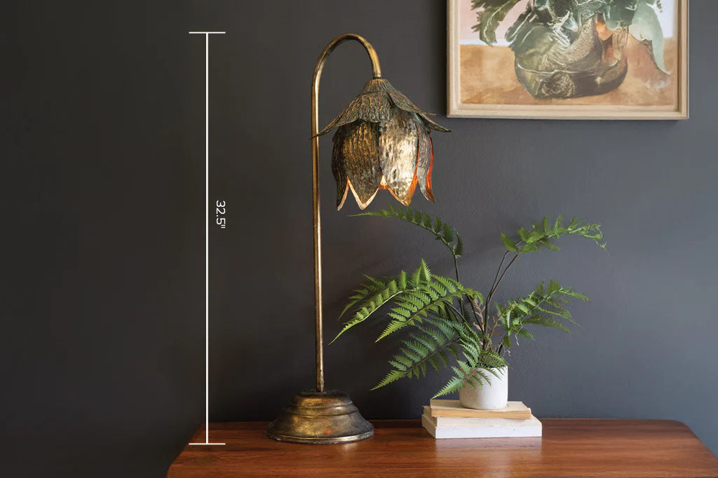 Decorative table lamp with floral design on a wooden surface against a dark wall with a framed picture. Text overlay of height of 32.5" shown