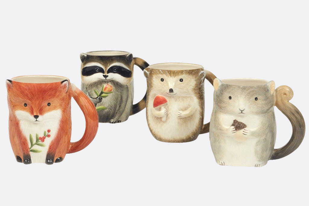 Set of four animal-themed mugs on a white background: fox, raccoon, hedgehog, and squirrel