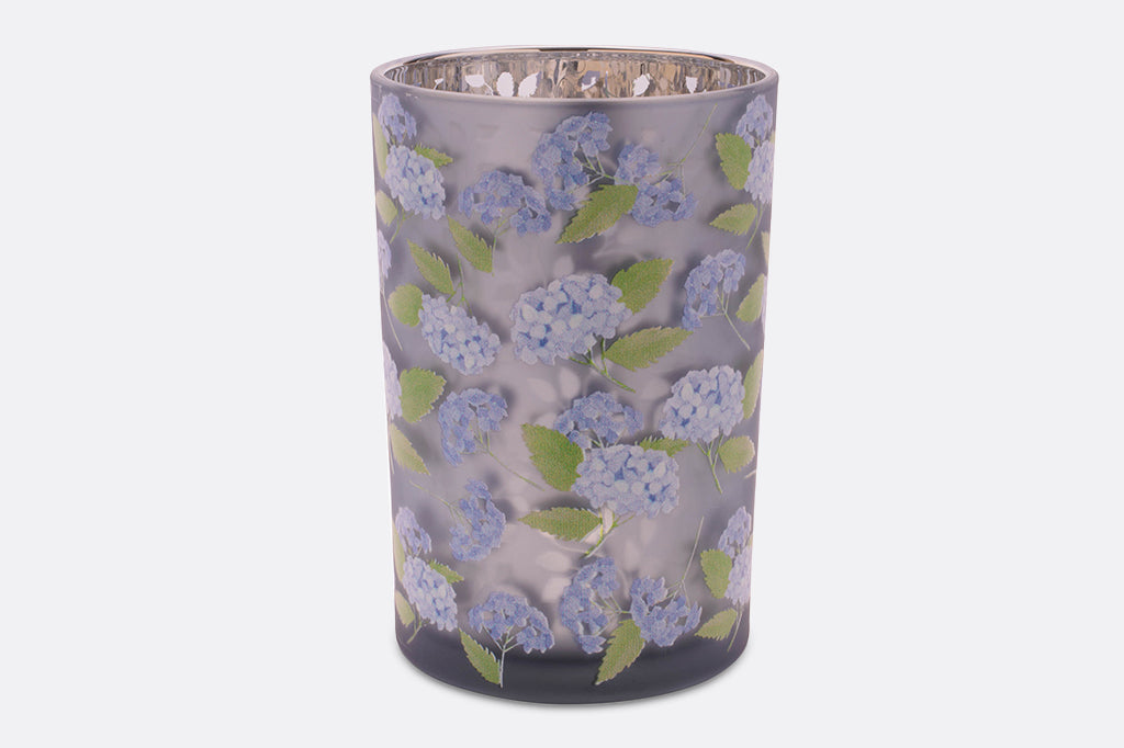 Two purple candleholders with a hydrangea flower design.