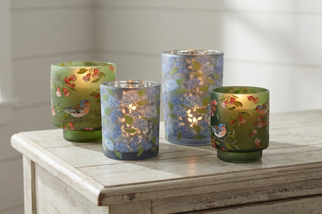 two pairs of glass candle vessels shown on wood countertop. VB87036 and VB70054