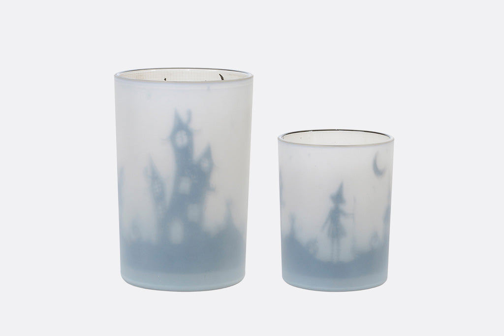 Two glass tumblers with a gradient blue and white design on a light gray background