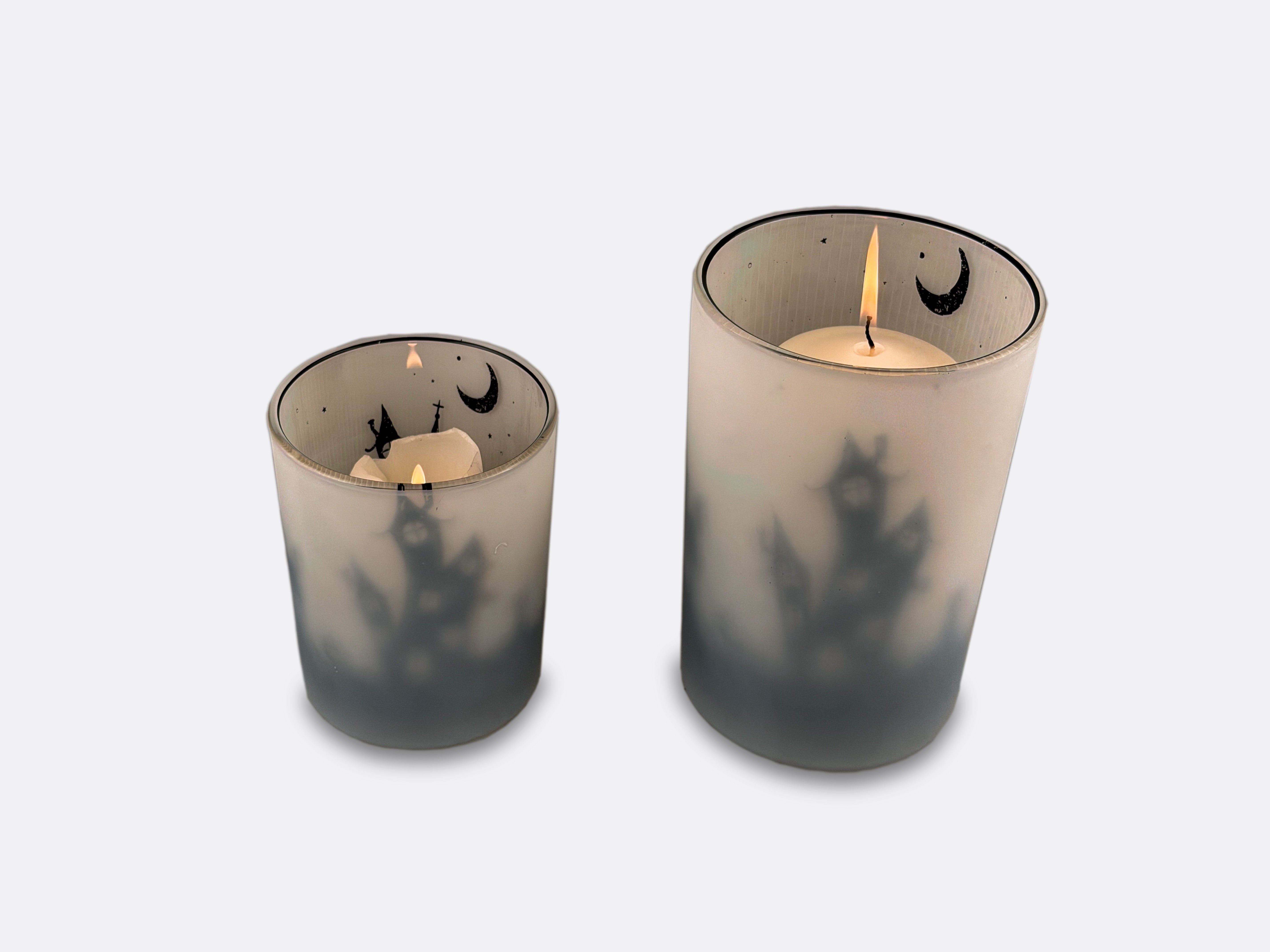 Two Halloween themed candle holders.