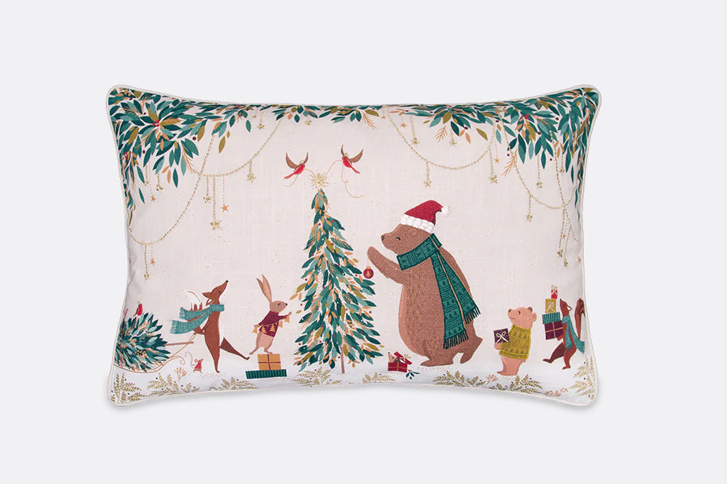 throw pillow with winter animals in christmas outfits and winter clothes decorating a christmas tree together