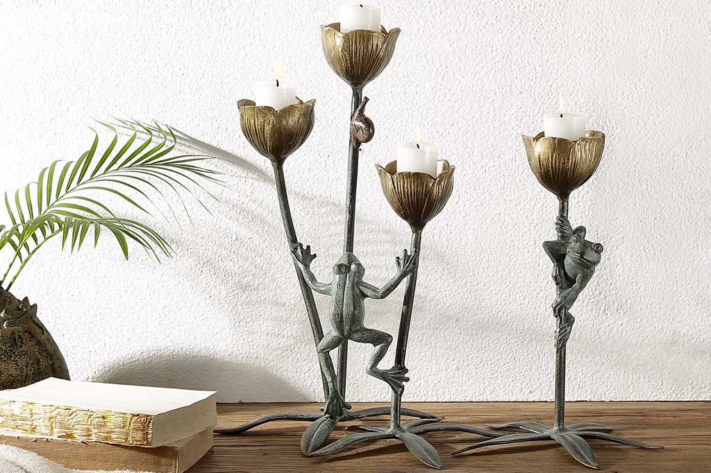 A curious frog watches a snail on a flower stem in a cast metail sculpture and votive candle, holds three candles in the blossoms holder