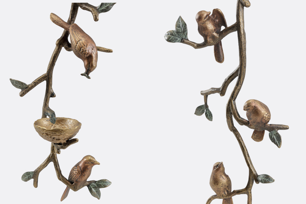 Pair of cast metal bird and nest wall sconces, holds two votive candles.