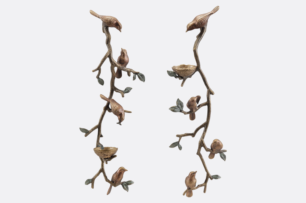 Pair of cast metal bird and nest wall sconces, holds two votive candles.