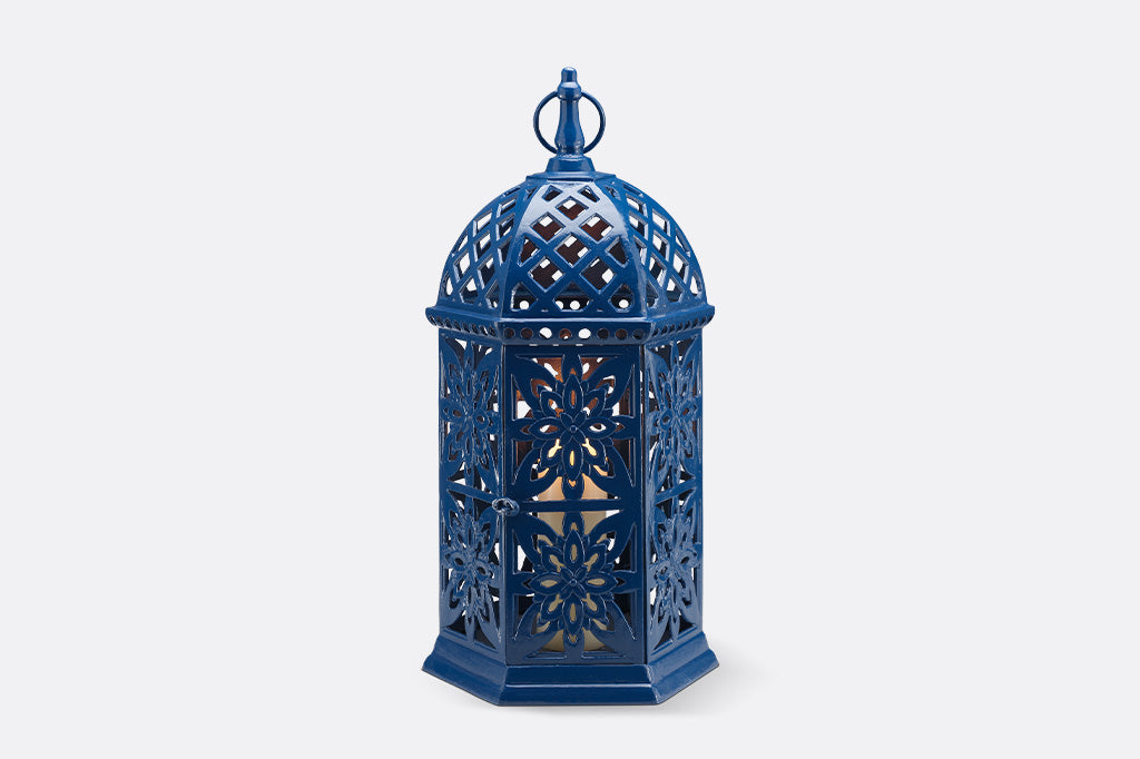 Moroccan inspired fretwork garden candle lantern with intricate patterns.