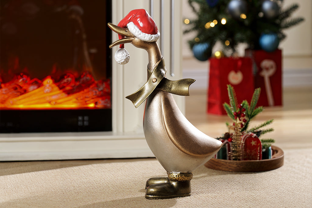 Decorative duck statue wearing a Santa hat in front of a fireplace with Christmas decorations.