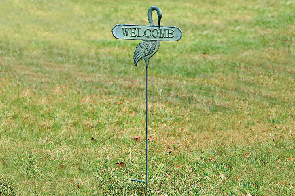 cast metal staked welcome sign with a flamingo