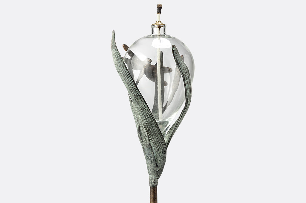 dragonfly and frond sculpted motif on glass oil torch