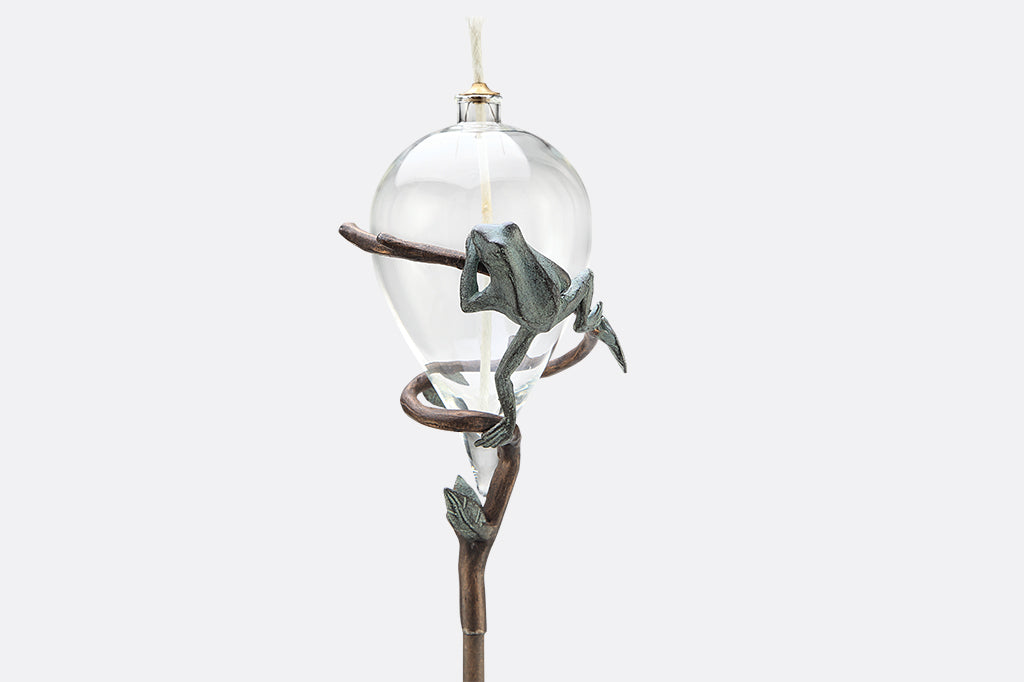 staked glass oil torch with frog on vine motif