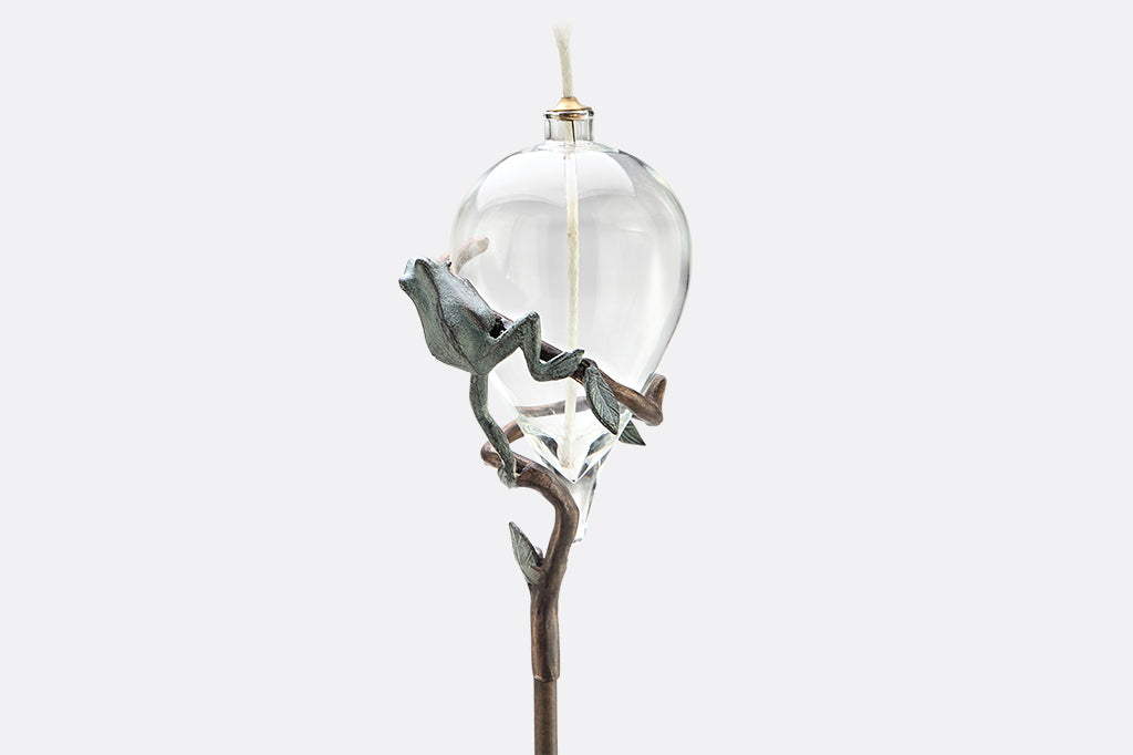 staked glass oil torch with frog on vine motif