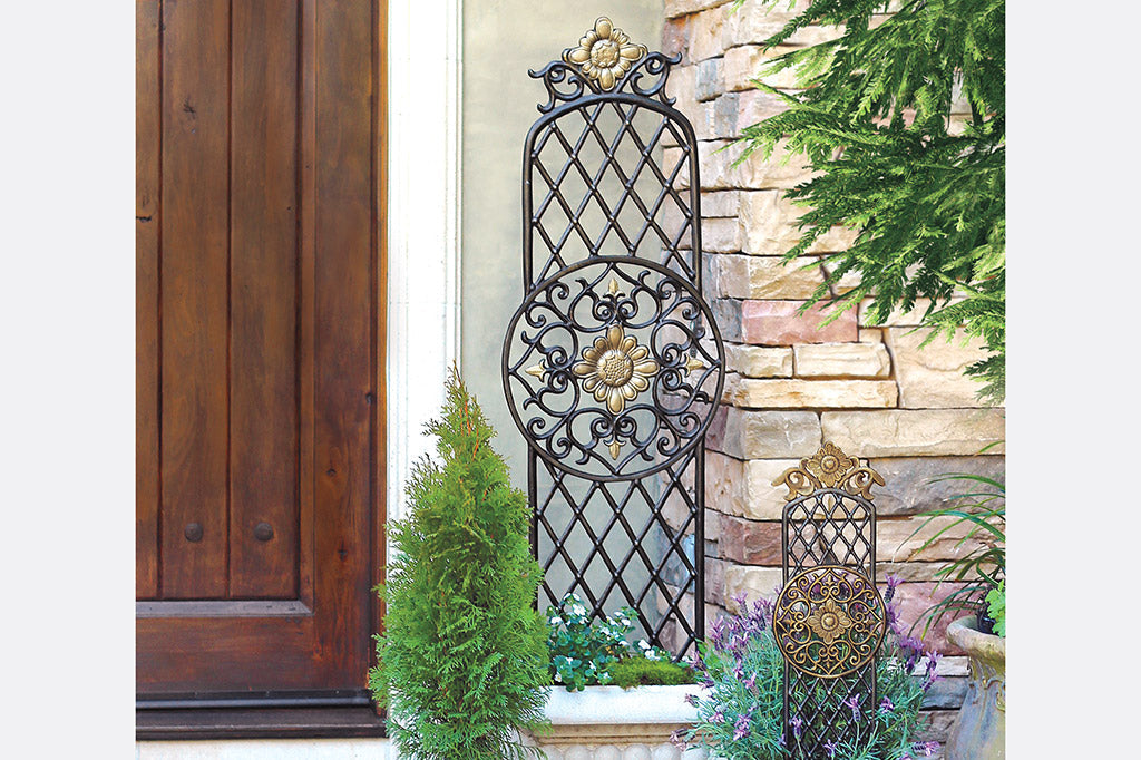 garden trellis with center sunflower medallion motif, surrounded by latice fretwork - shown in large planter in front of home