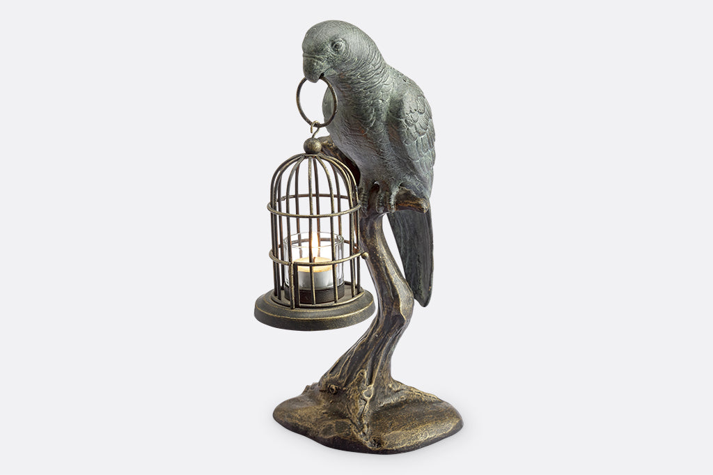 cast metal parrot seating on branch holding birdcage with tealight sculpture