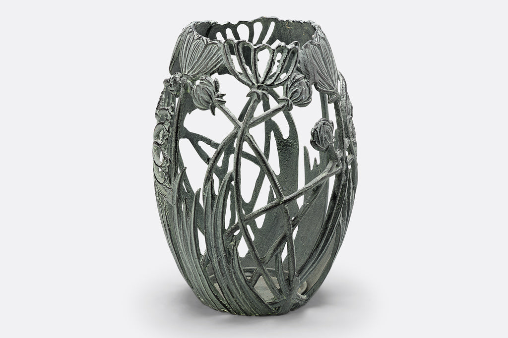 Side view of A Garden Party Candleholder, featuring long stemmed blossoms and grasses