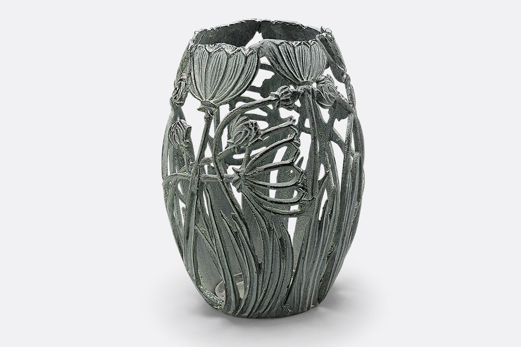 Side view of A Garden Party Candleholder, featuring long stemmed blossoms and grasses